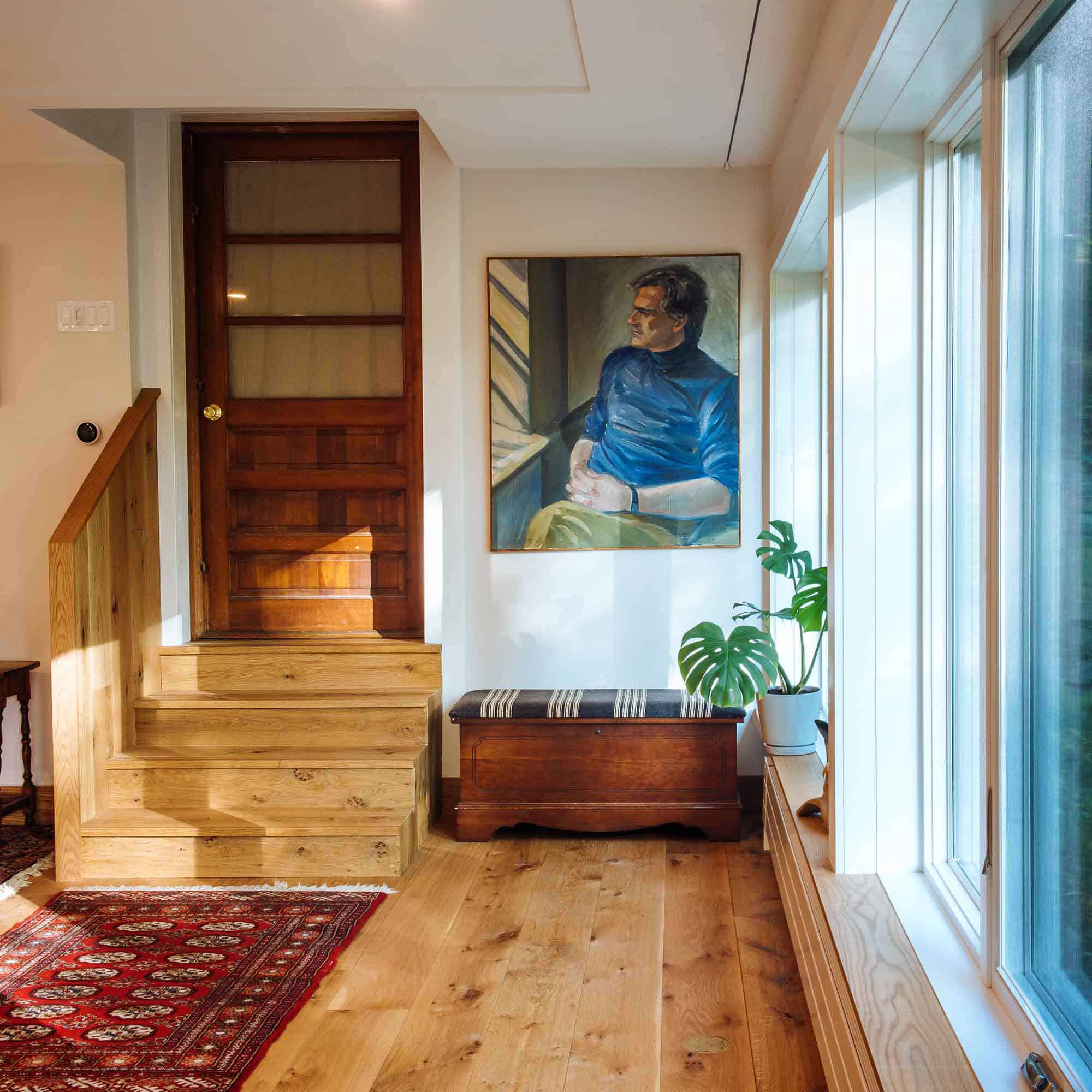 Interior stairs up to a heavy wooden door at the entrance to the master bedroom